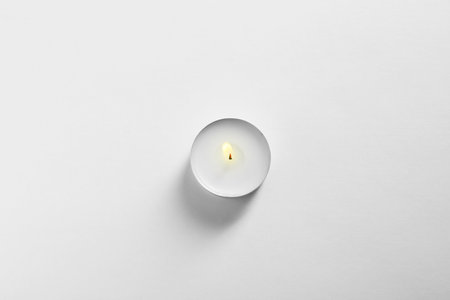 Burning wax candle on white background, top viewの写真素材