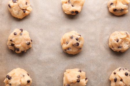 Cookie dough with chocolate chips on parchment, top viewの写真素材
