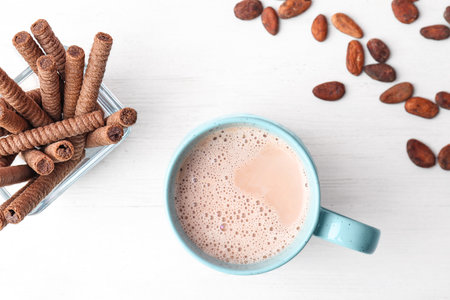 Mug with delicious hot cocoa drink and cookies on table, top viewの写真素材