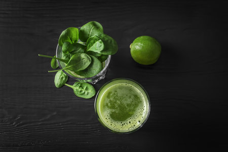 Glasses with delicious detox juice and ingredients on dark background, top viewの写真素材