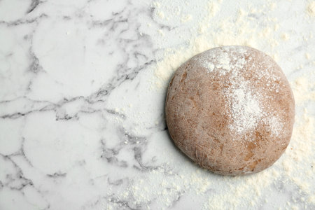 Fresh rye dough with flour on marble background, top viewの写真素材