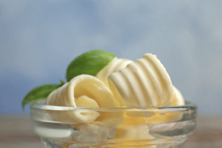 Bowl with tasty butter curls, closeup