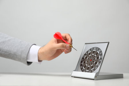 Man with darts at table. business trainer conceptの写真素材