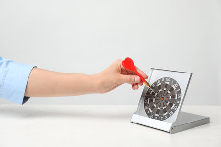 Woman with darts at table. business trainer conceptの写真素材
