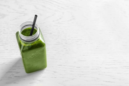 Bottle with delicious detox juice on light backgroundの写真素材