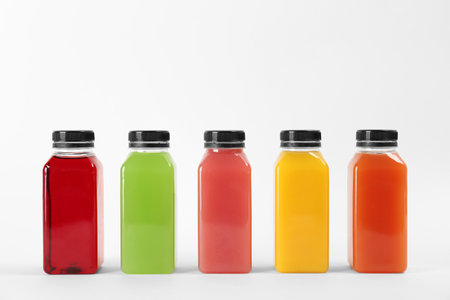 Bottles with delicious colorful juices on white backgroundの写真素材