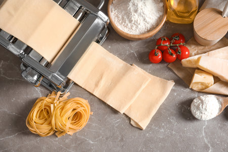 Pasta maker with dough and products on table, top viewの写真素材
