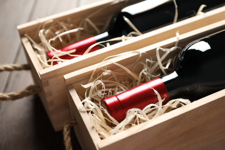 Bottles with delicious red wine in wooden boxes, closeupの写真素材