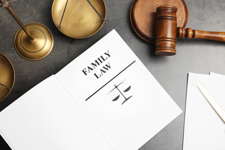 Flat lay composition with book, gavel and scales of justice on gray background. family law conceptの写真素材