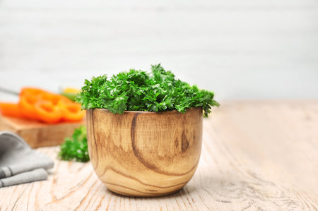 Bowl with fresh green parsley on tableの写真素材