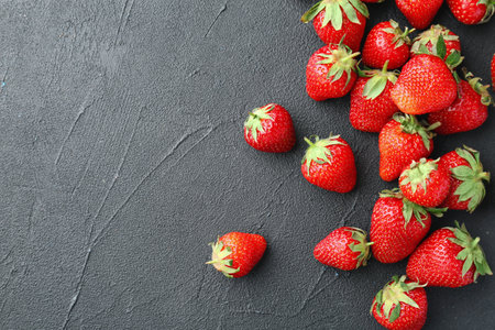 Ripe red strawberries on black background, top viewの写真素材