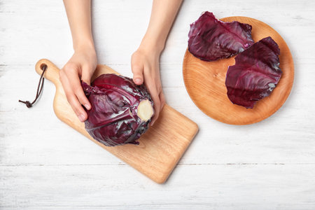 Woman preparing red cabbage at table, top viewの写真素材