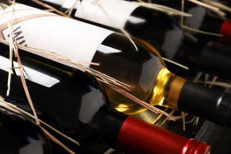 Bottles with delicious wine on shelf, closeup. professional sommelierの写真素材