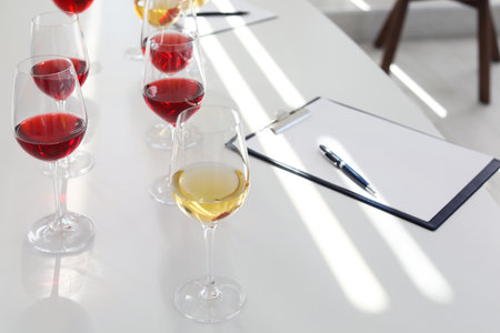 Glasses with delicious wine on table indoorsの写真素材