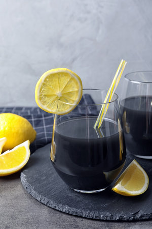 Glasses with natural black lemonade on tableの写真素材