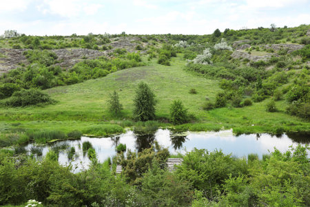 Beautiful landscape with beautiful pond and rocky hill. camping seasonの写真素材