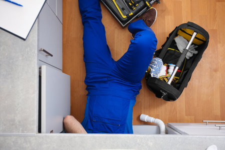Professional plumber with set of tools working indoors, top viewの写真素材
