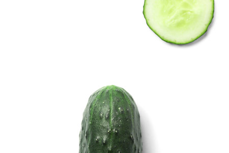 Flat lay composition with slices of cucumber on white backgroundの写真素材