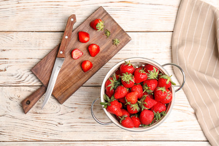 Flat lay composition with ripe red strawberries on wooden backgroundの写真素材