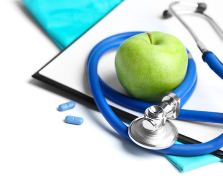 Stethoscope, clipboard and apple on light background. medical equipmentの写真素材