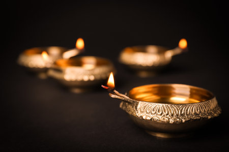 Diwali diyas or clay lamps on dark background
