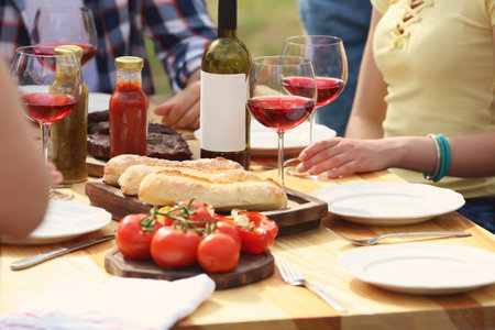 Young people having picnic at table outdoorsの写真素材
