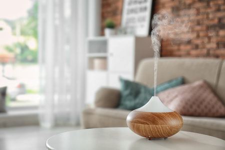 Aroma oil diffuser on table at home. air freshenerの写真素材
