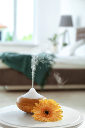Aroma oil diffuser on table at home. air freshener