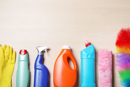Flat lay composition with cleaning supplies on wooden backgroundの写真素材