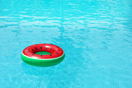Inflatable ring floating in pool on sunny dayの写真素材