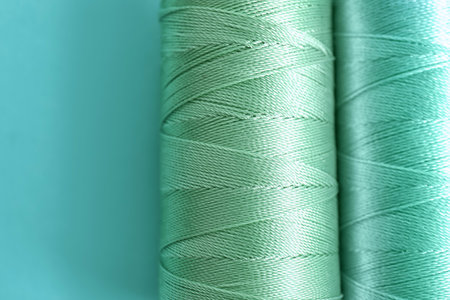 Mint color sewing threads on table, closeupの写真素材