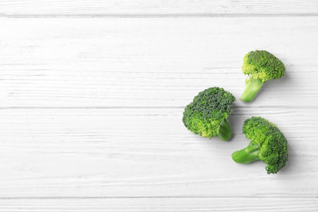 Fresh green broccoli on wooden background, top viewの写真素材