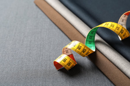 Measuring tape on fabric, closeup. tailoring equipment