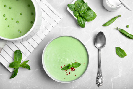 Flat lay composition with green pea soup on gray backgroundの写真素材