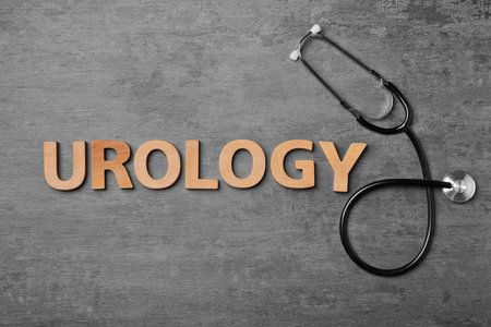 Word "UROLOGY" made with wooden letters and stethoscope on table, top viewの写真素材