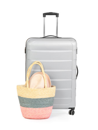 Suitcase and tote bag with hat on white backgroundの写真素材