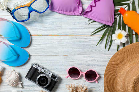 Flat lay composition with beach objects on wooden background