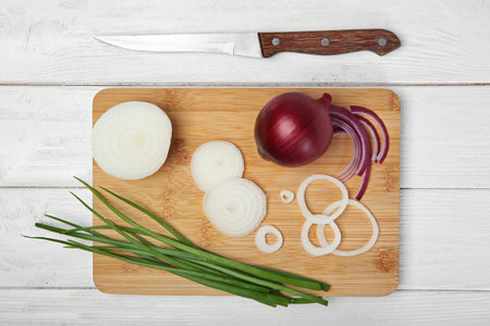 Flat lay composition with fresh onions on wooden backgroundの写真素材