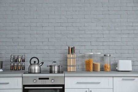 Modern kitchen interior with new furniture and different utensils