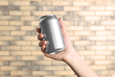 woman holding aluminum can on blurred backgroundの写真素材
