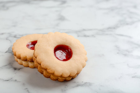 Traditional Christmas Linzer cookies with sweet jam on marble backgroundの写真素材