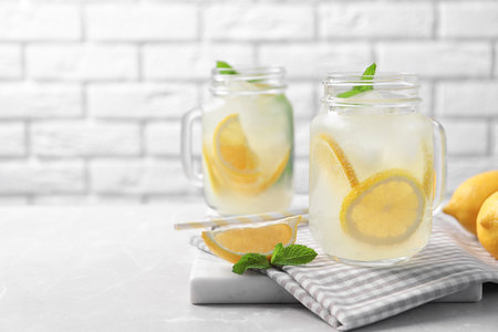 Mason jars of natural lemonade on tableの写真素材