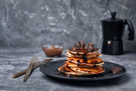 Tasty pancakes with chocolate on tableの写真素材