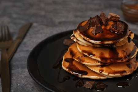 Tasty pancakes with chocolate on tableの写真素材