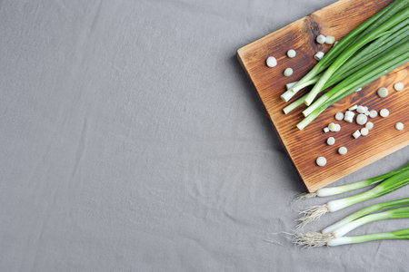 Beautiful composition with fresh green onion on table, top viewの写真素材