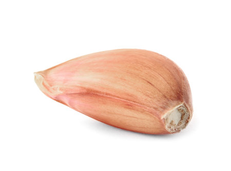 Fresh unpeeled garlic clove on white backgroundの写真素材