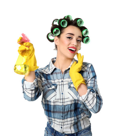 Funny young housewife with hair rollers holding detergent on white backgroundの写真素材