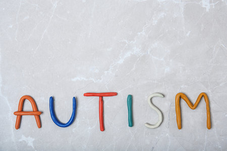 Word AUTISM made of plastic on light background, top viewの写真素材