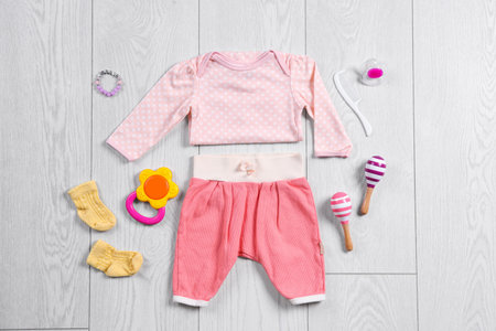 Flat lay composition with stylish child clothes and accessories on wooden backgroundの写真素材