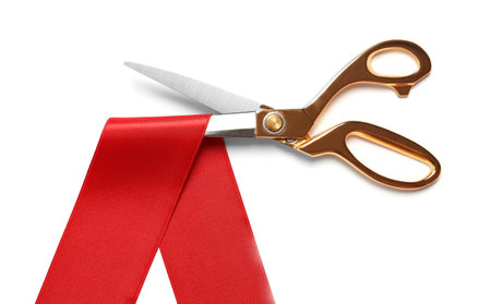Ribbon and scissors on white background, top view. Ceremonial red tape cuttingの写真素材